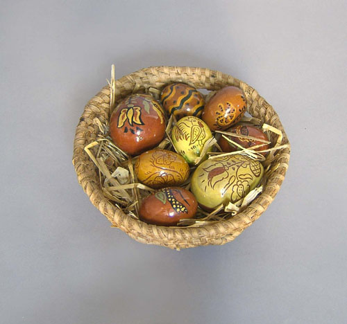 Appraisal: Rye straw basket x dia with eight redware eggs by