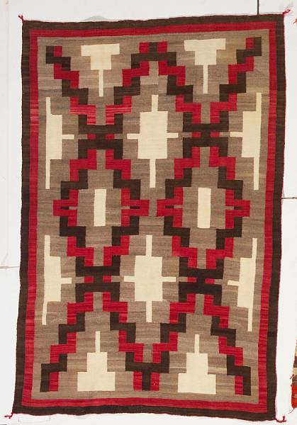 Appraisal: A Navajo rug A matrix of interlaced diamonds stepped pyramids