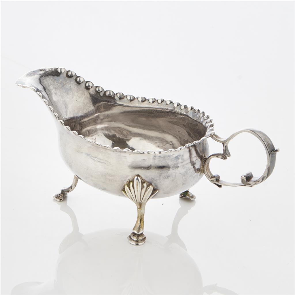 Appraisal: A George III sauceboat WC London with everted beaded rim