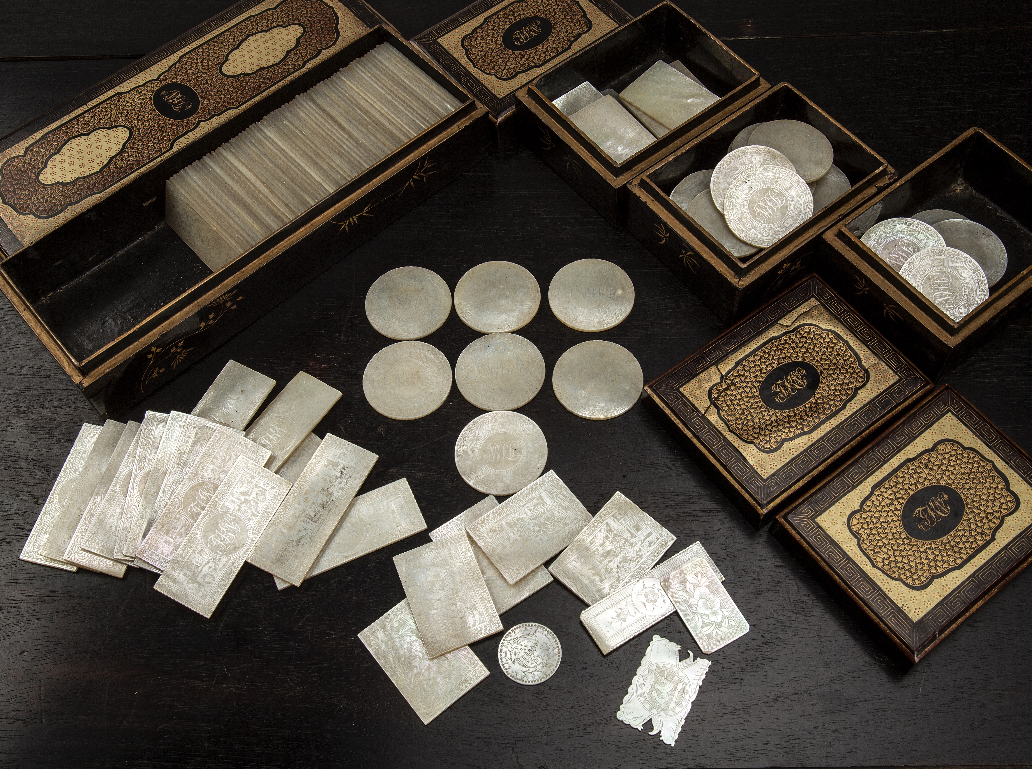 Appraisal: Collection of mother-of-pearl gaming counters and lacquer boxes and traysChinese