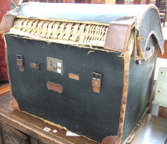 Appraisal: A wicker domed travelling trunk with leather cover bears label