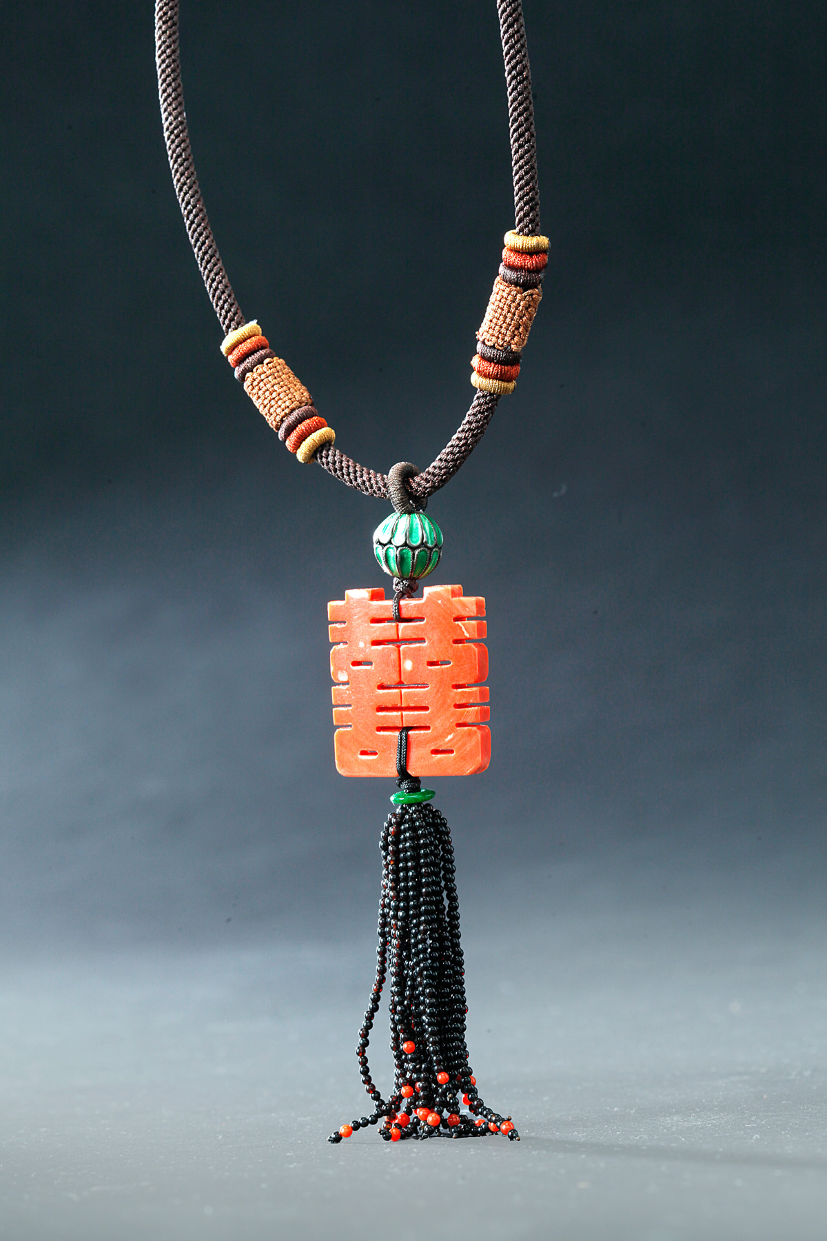 Appraisal: CARVED CHINESE CORAL NECKLACE Late th century Carved pendant with