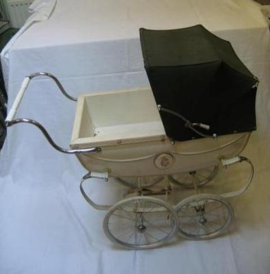 Appraisal: A Silver Cross doll's perambulator coach built with canvas hood