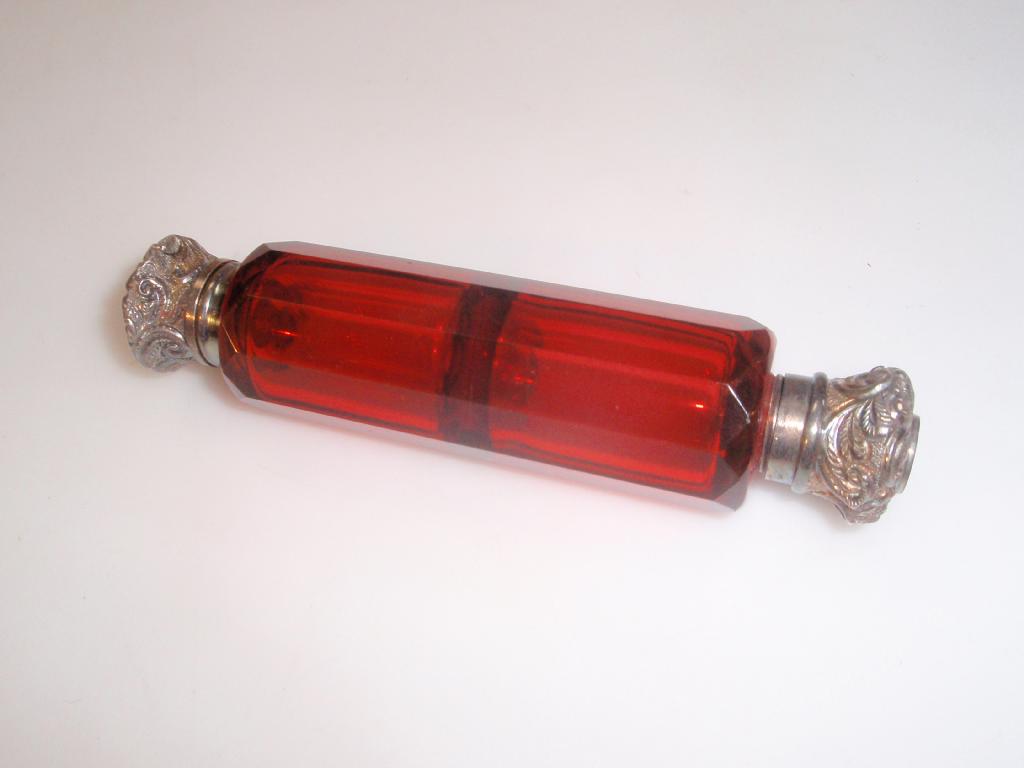 Appraisal: A cranberry glass double end perfume bottle with white metal