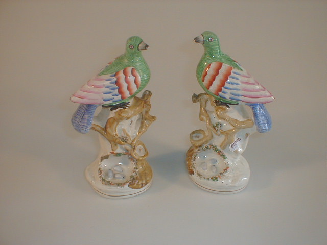 Appraisal: A pair of Victorian Staffordshire pottery bird groups each modelled