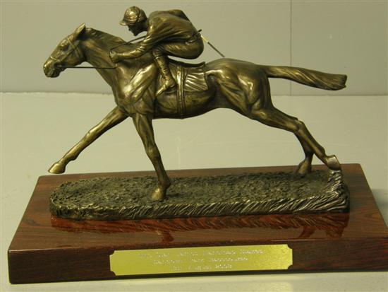 Appraisal: Bronze horse racing trophy on mahogany base with gilt metal