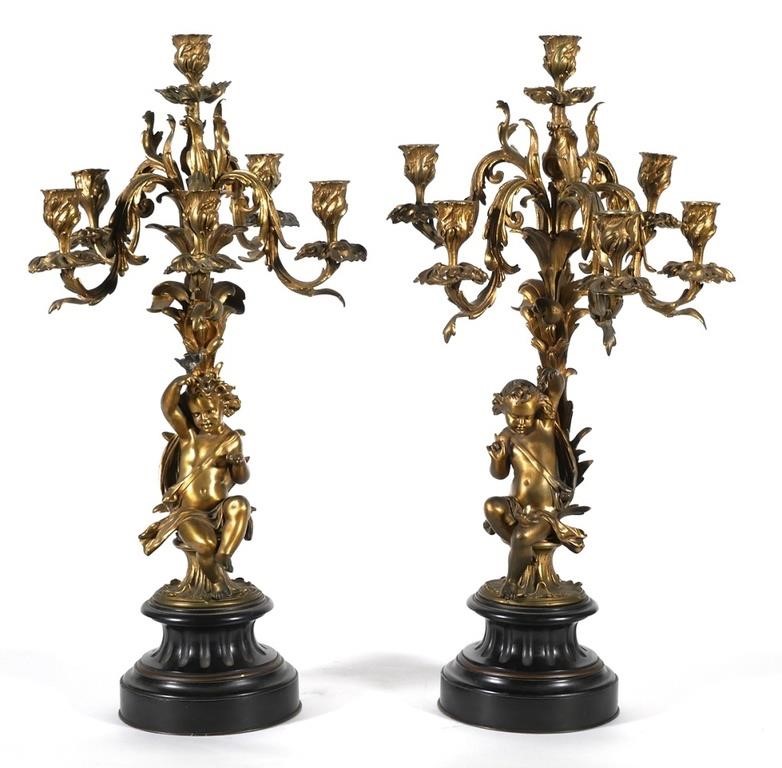 Appraisal: Pair of Cherub base gilt bronze candelabra apparently formerly electrified