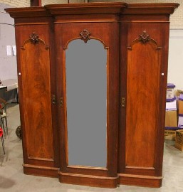 Appraisal: A Victorian mahogany breakfront three door wardrobe with central mirrored