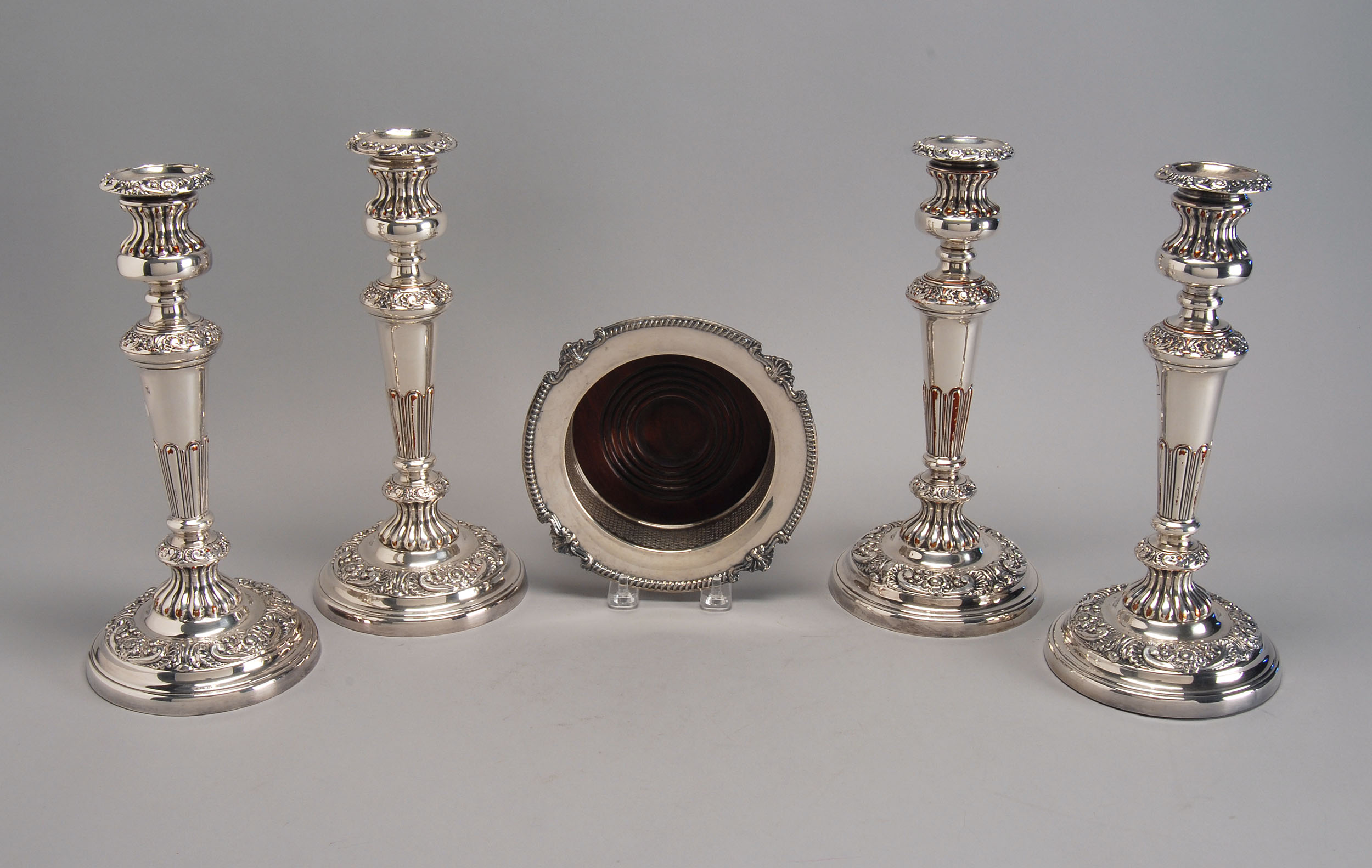 Appraisal: FOUR ENGLISH SILVER PLATED CANDLESTICKS in column form with ribbed