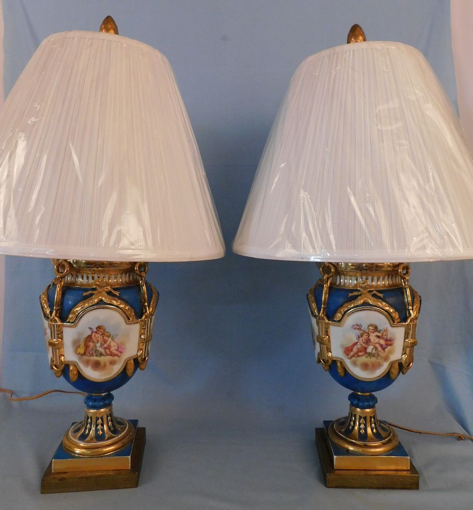 Appraisal: PAIR FRENCH PAINTED PORCELAIN LAMPS - CHERUBS FLOWERS Pair antique