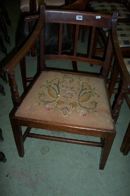 Appraisal: A Georgian mahogany armchair with fluted arms drop in seat