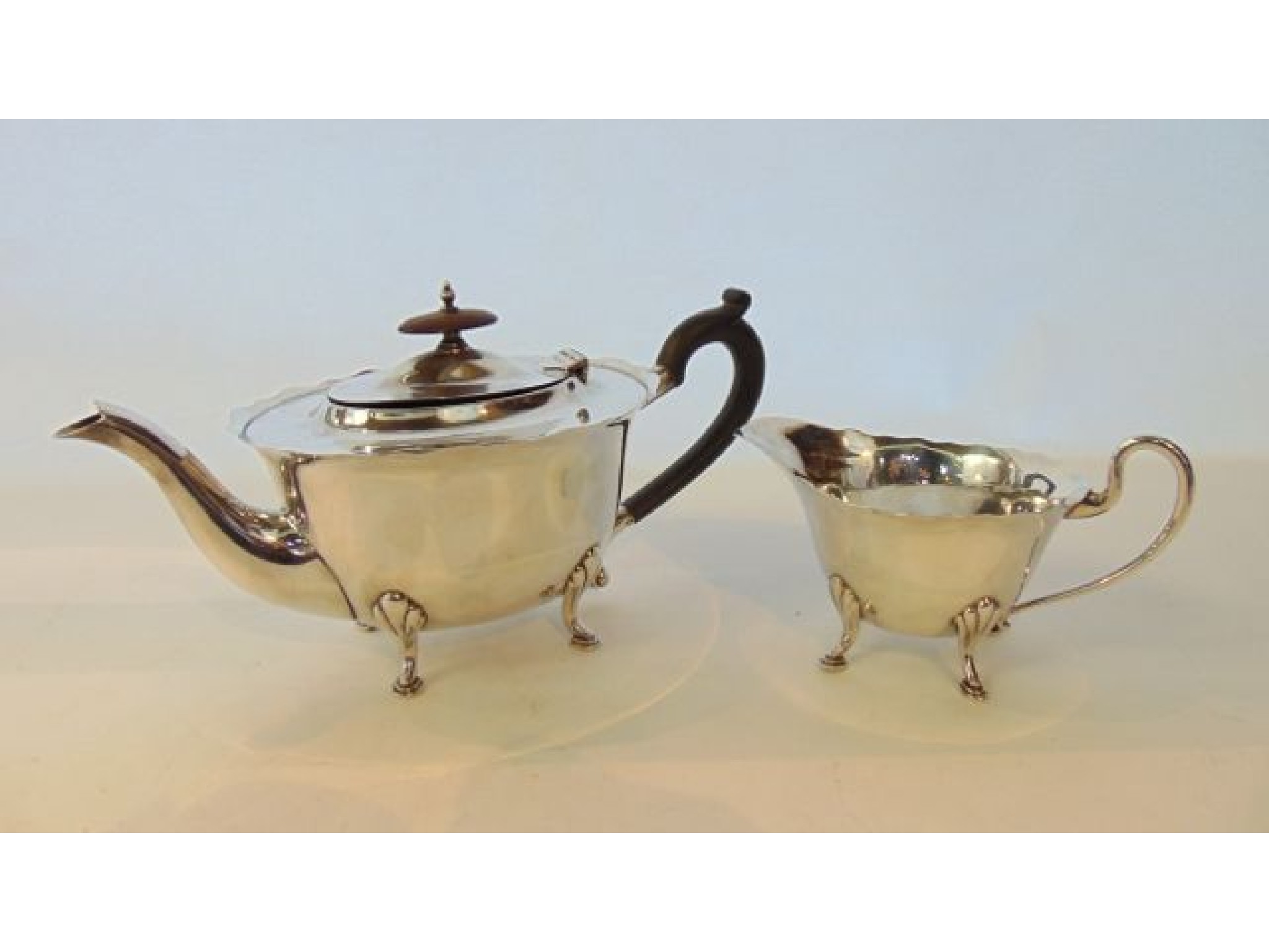 Appraisal: A George V silver teapot and milk jug Walker Hall