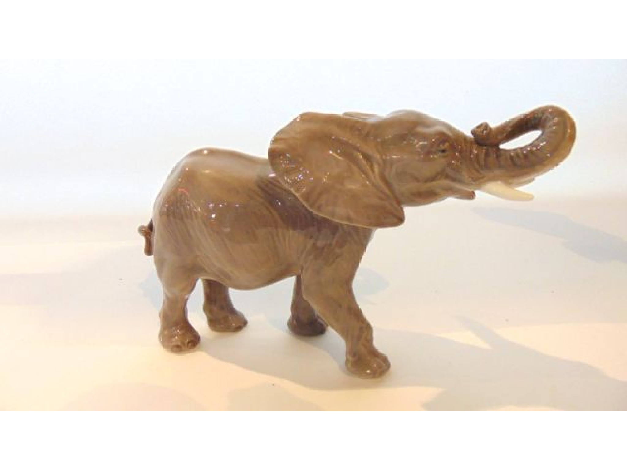 Appraisal: A Royal Copenhagen model of an elephant with curled trunk