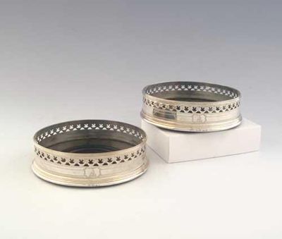 Appraisal: A pair of George III pierced wine coasters with reeded