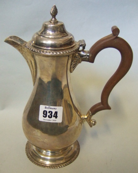 Appraisal: A silver hot water jug of baluster form decorated with