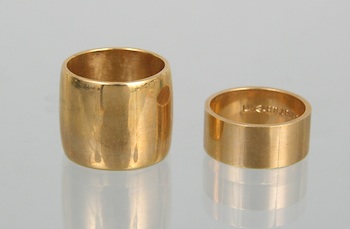 Appraisal: Two k Gold Bands Containing a wide k yellow gold