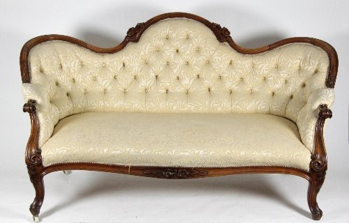 Appraisal: A Victorian walnut settee with carved and moulded frame on