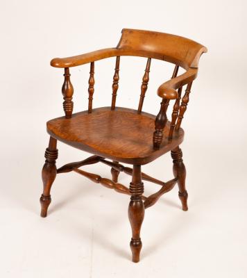 Appraisal: A Victorian smokers bow chair with shaped arms and raised