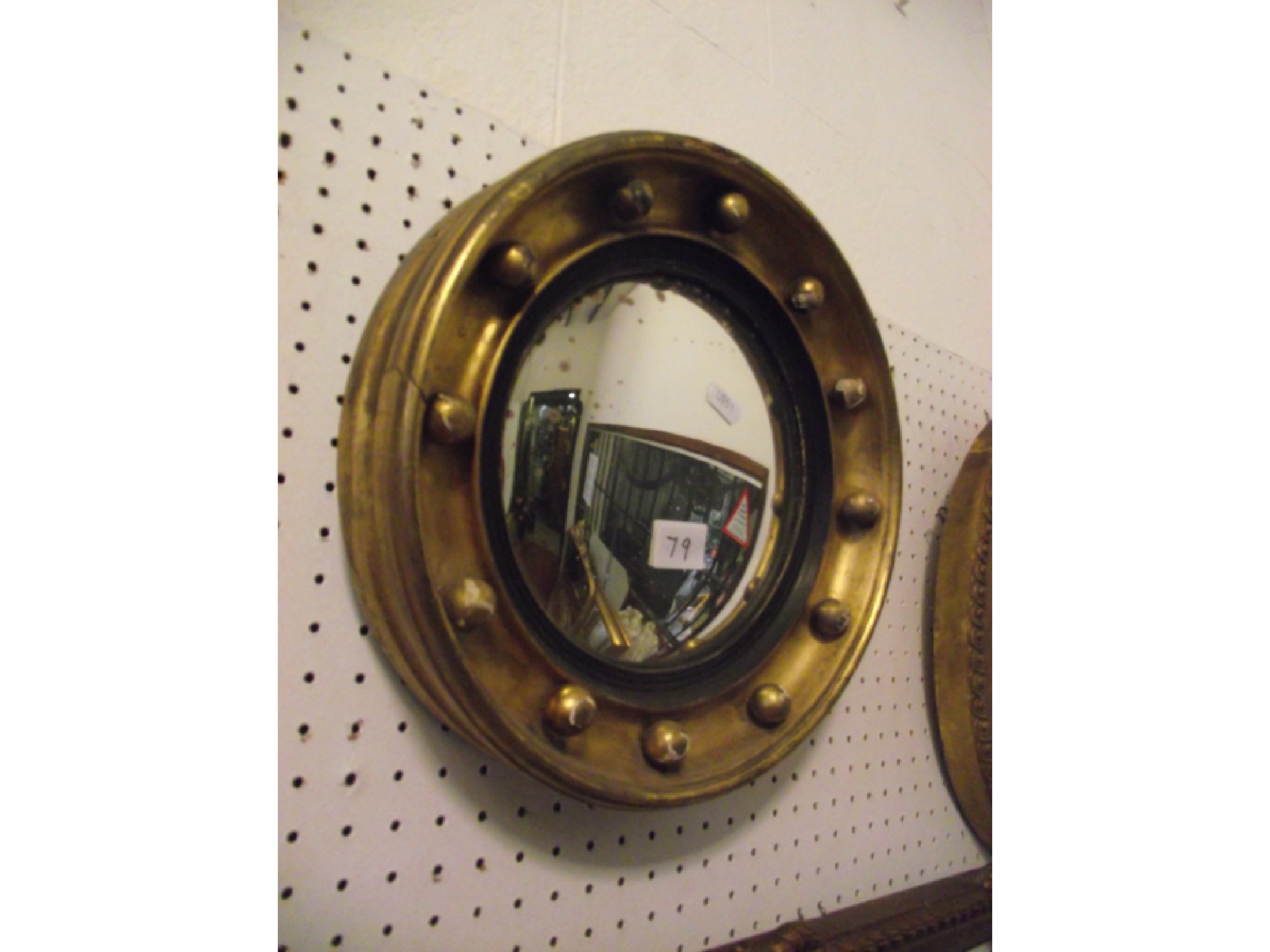 Appraisal: A small th century gilt framed convex wall mirror with