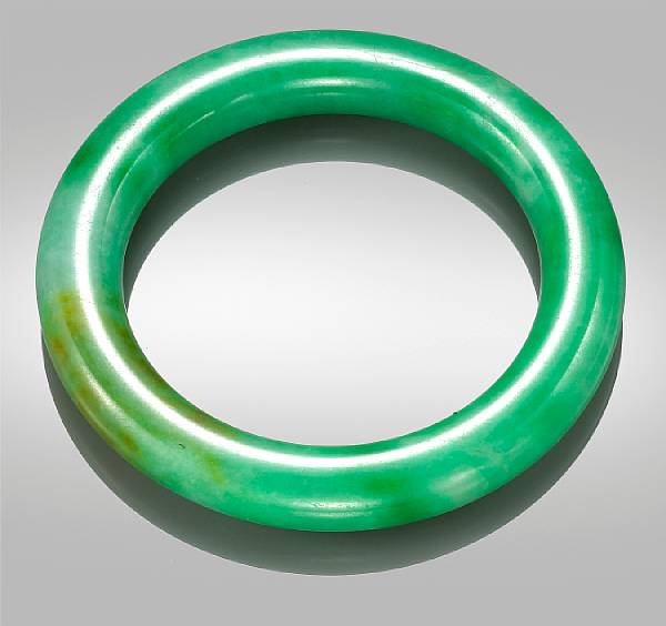 Appraisal: A fine green jadeite bangle Of simple circular form the