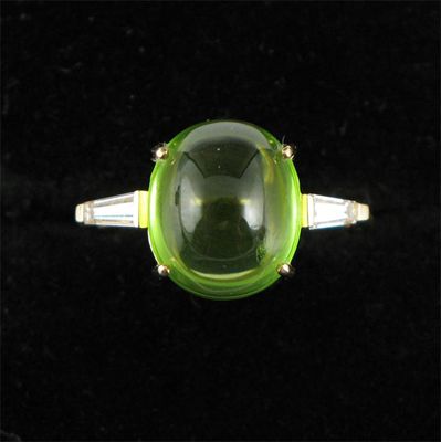 Appraisal: A cabochon peridot and tapered baguette shaped diamond ring Set