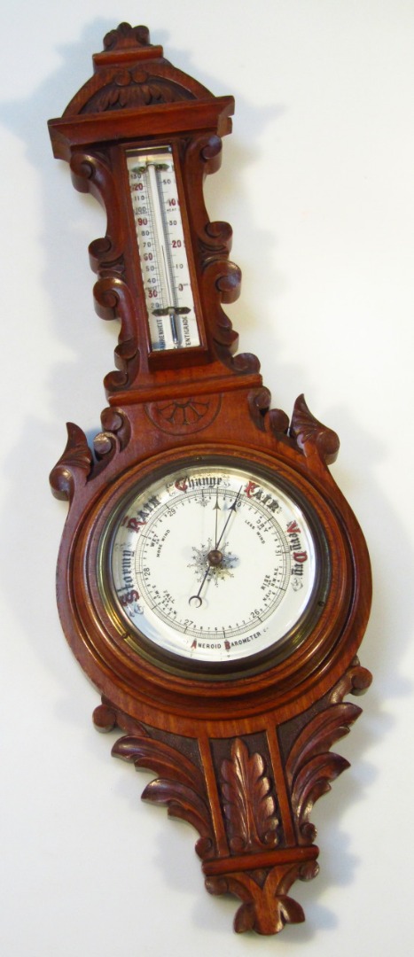 Appraisal: An early thC two dial barometer the walnut case holding