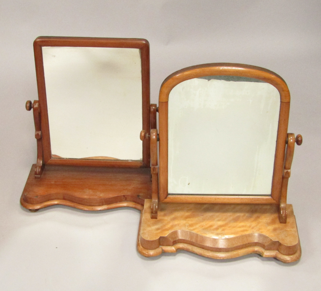 Appraisal: A Victorian mahogany swing frame toilet mirror raised on a