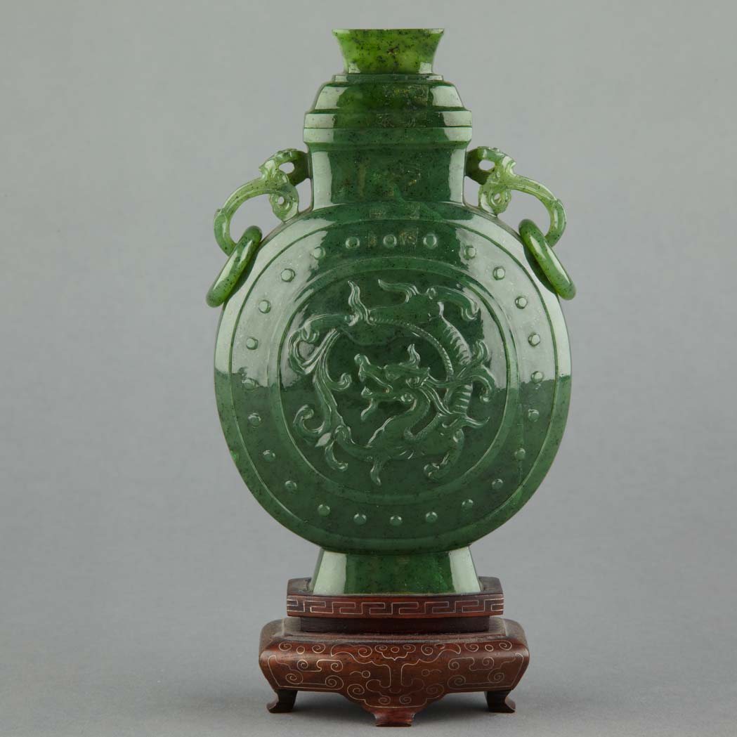 Appraisal: Chinese Spinach Jade Covered Vase The flattened circular body carved