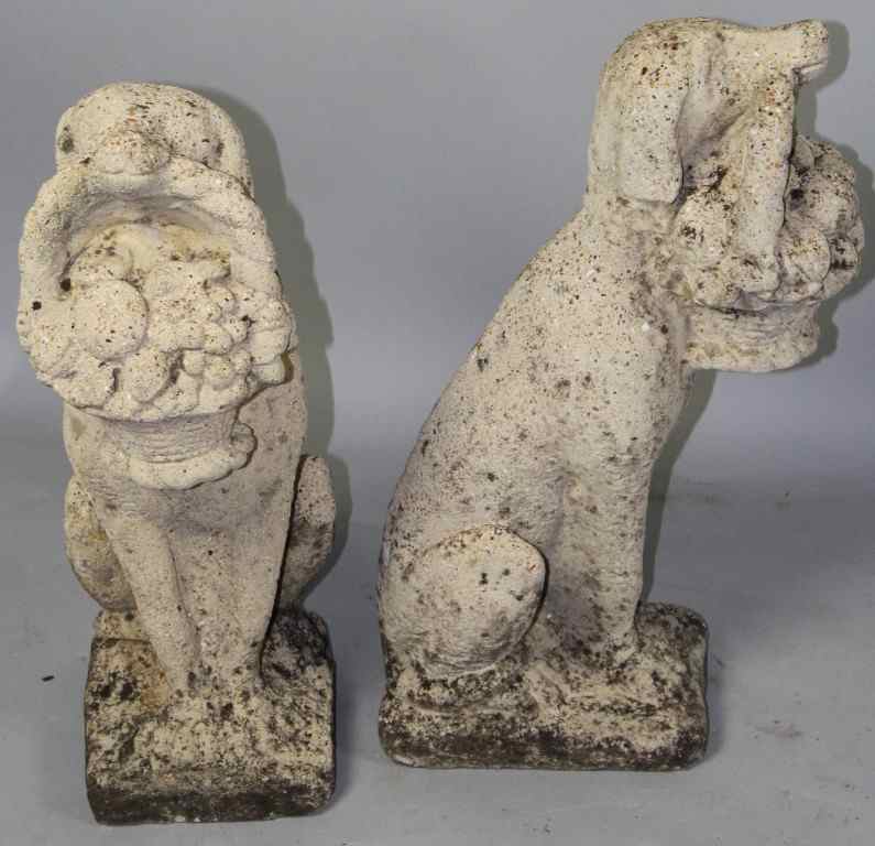 Appraisal: PAIR ENGLISH CAST STONE COMPOSITE GARDEN FIGURES OF DOGS HOLDING