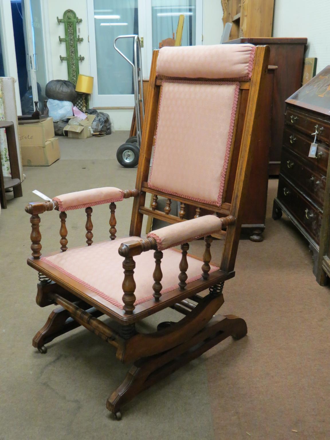 Appraisal: An early th century walnut rocking armchair with turned spindles