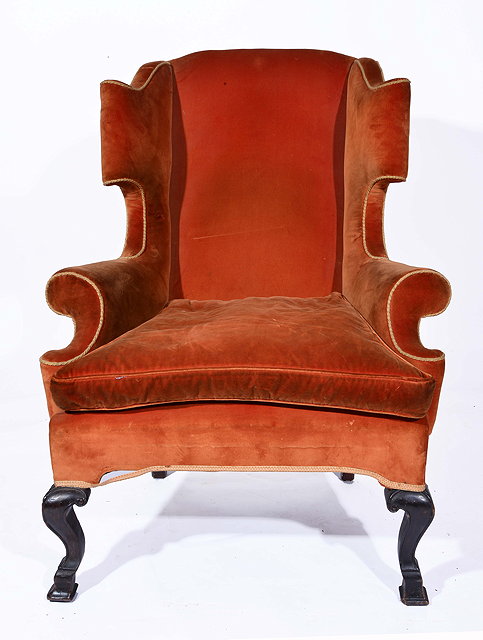 Appraisal: AN ANTIQUE ORANGE UPHOLSTERED WING BACK ARMCHAIR with carved square