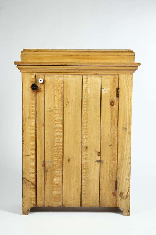 Appraisal: ONE DOOR CABINET Yellow grain decorated pine with a stepped