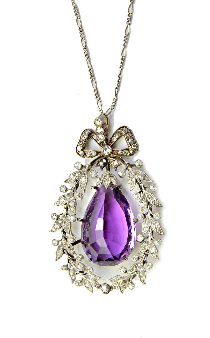 Appraisal: An amethyst and diamond pendant in a drop shaped wreath