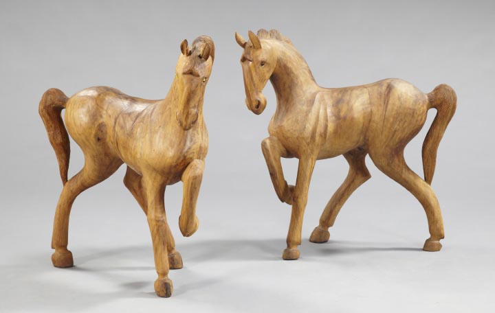 Appraisal: Pair of Continental Carved Elm Figures of Prancing Equine Figures