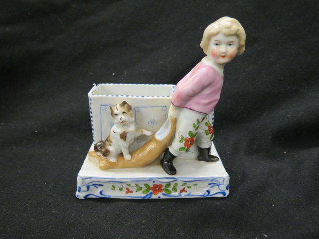 Appraisal: German Porcelain Figural Smoking Standwith child pulling a cat on