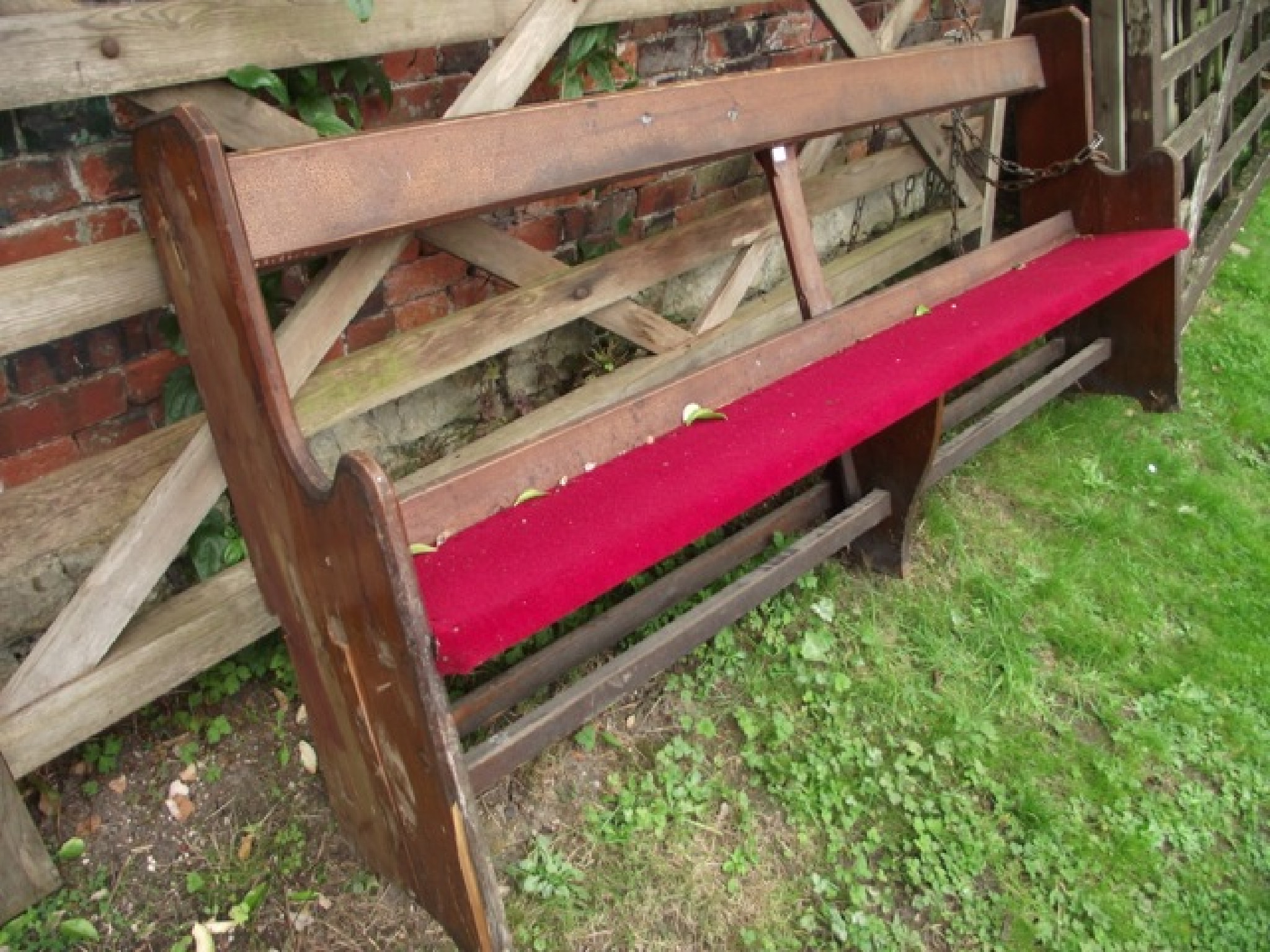 Appraisal: A reclaimed pitch pine church pew with shaped ends and