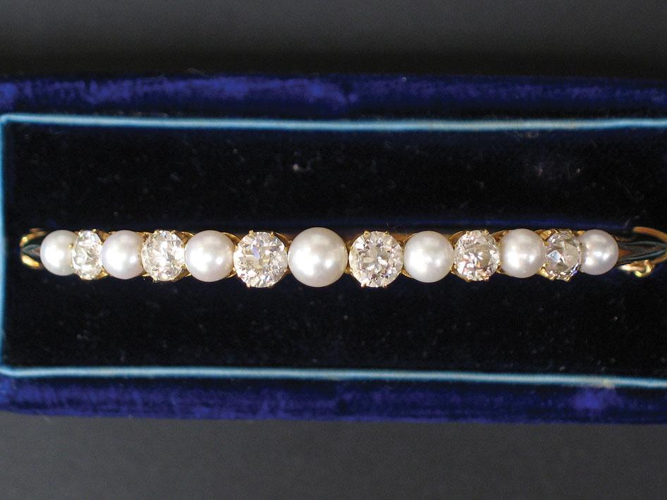 Appraisal: A PEARL AND DIAMOND-SET BANGLE in yellow gold untested set