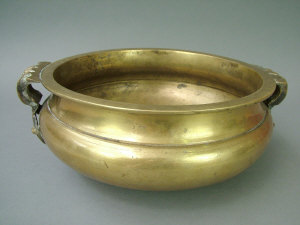 Appraisal: A Chinese bronze circular shallow waisted bowl of archaic form