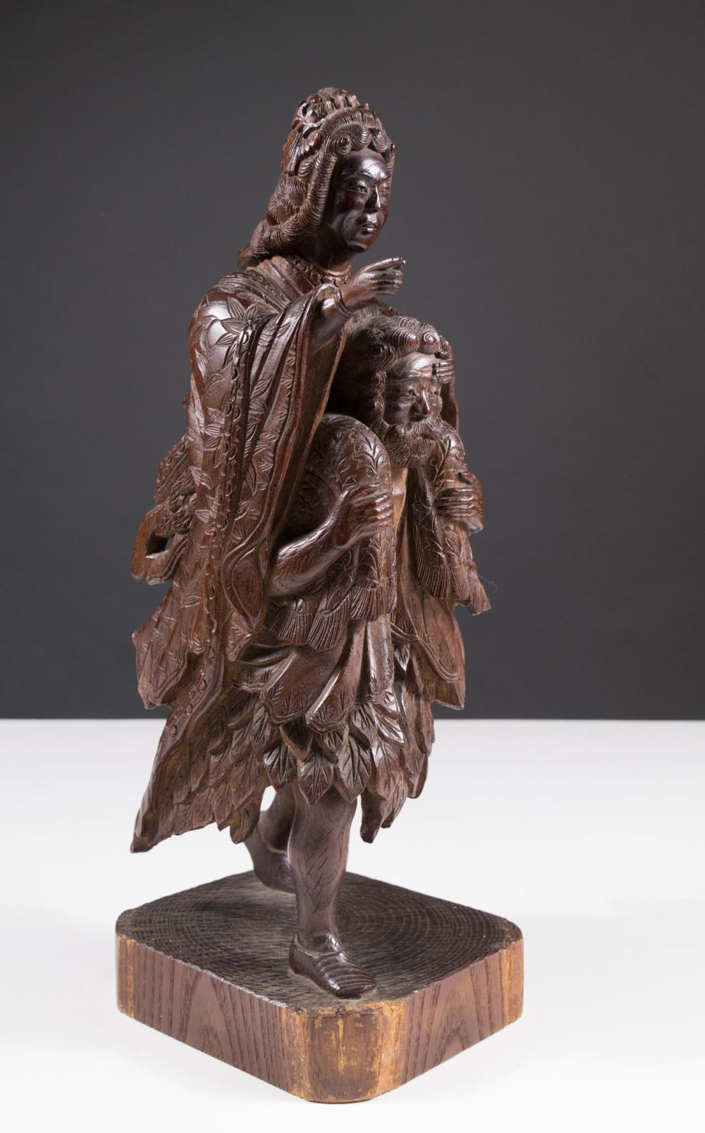 Appraisal: JAPANESE CARVED WOOD FIGURAL GROUP SCULPTURE depicting a man carrying