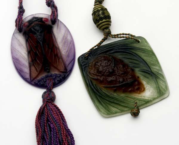 Appraisal: ARGY ROUSSEAU Two pendants one with pine cone the other