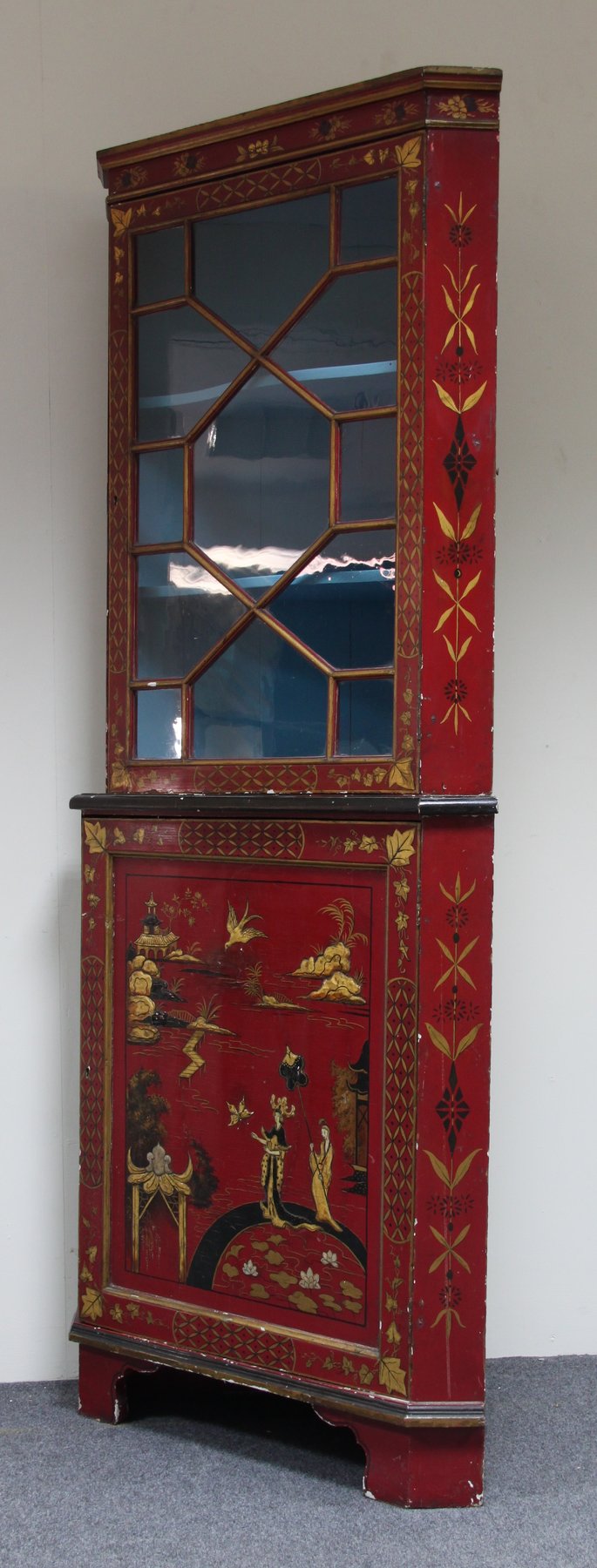 Appraisal: A lacquered corner cupboard with astragal glazed upper section on