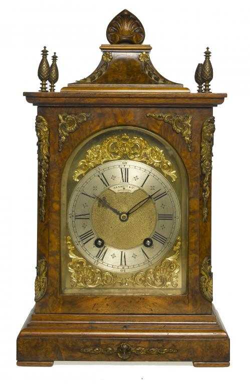 Appraisal: A GERMAN GILT BRASS-MOUNTED WALNUT CLOCK the arched dial with