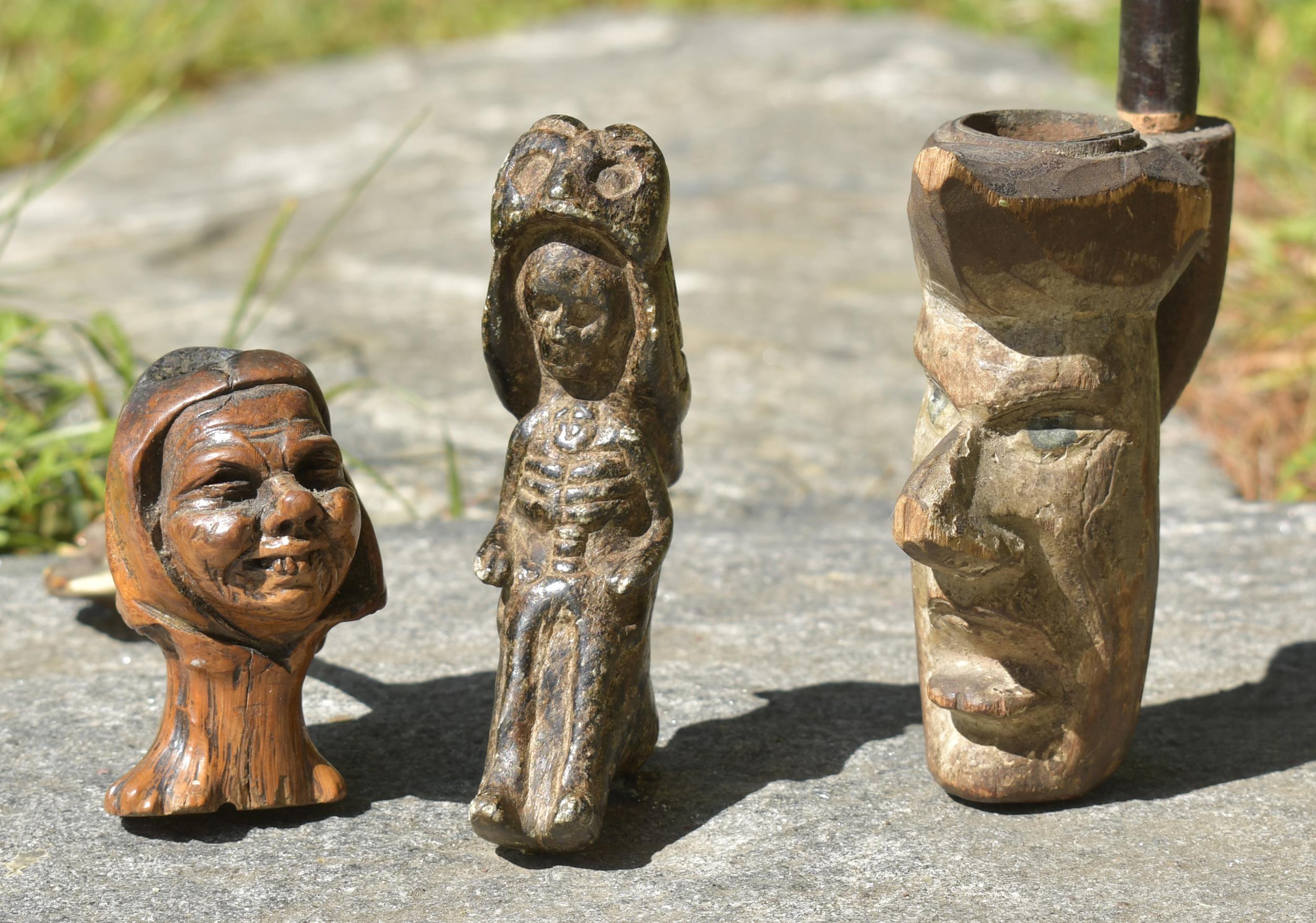 Appraisal: THREE EARLY CARVED PIPES A carved and painted wood facial