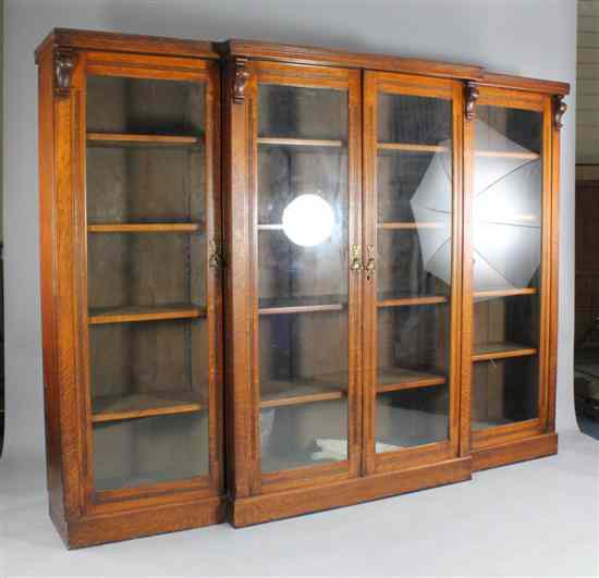 Appraisal: An Edwardian breakfront oak bookcase with four glazed doors on