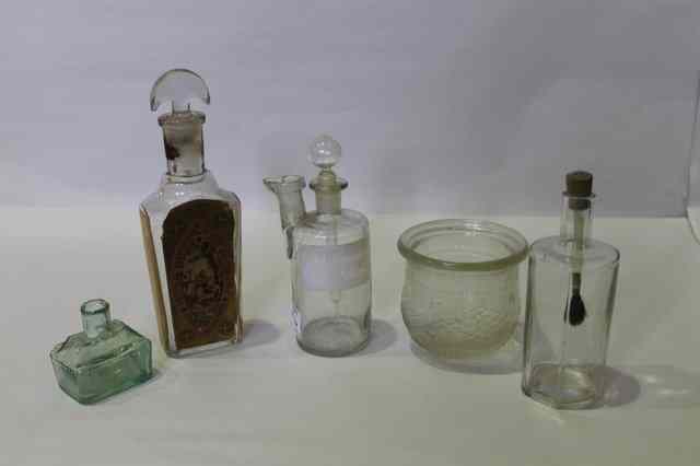 Appraisal: TWO VICTORIAN GLASS FUNNELS a few old medicine bottles an