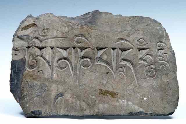 Appraisal: A TIBETAN CARVED SLATE PRAYER STONE incised inscription and of