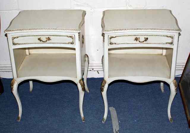 Appraisal: A PAIR OF ITALIANATE CREAM AND GILT PAINTED BEDSIDE CUPBOARDS