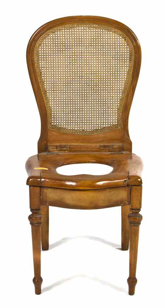 Appraisal: A Continental Pine Commode Chair having a caned back and