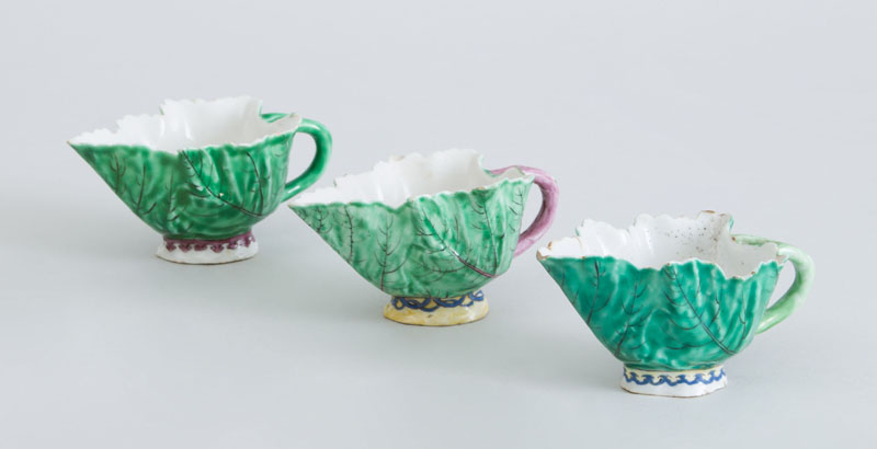 Appraisal: THREE CHELSEA PORCELAIN LEAF-FORM CUPS Unmarked variously with blue loop