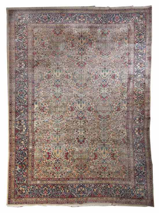 Appraisal: A Kirman Wool Rug having repeating stylized floral medallions on